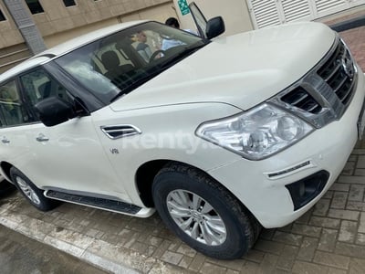 Bright White Nissan Patrol for rent in Abu-Dhabi 0