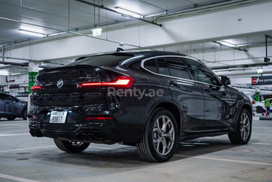 Black 2020 BMW X4 with X4M Body Kit for rent in Sharjah 1