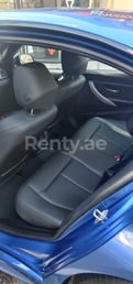 Blue BMW 318 for rent in Sharjah 4