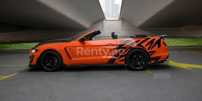 Orange Ford Mustang for rent in Dubai 1