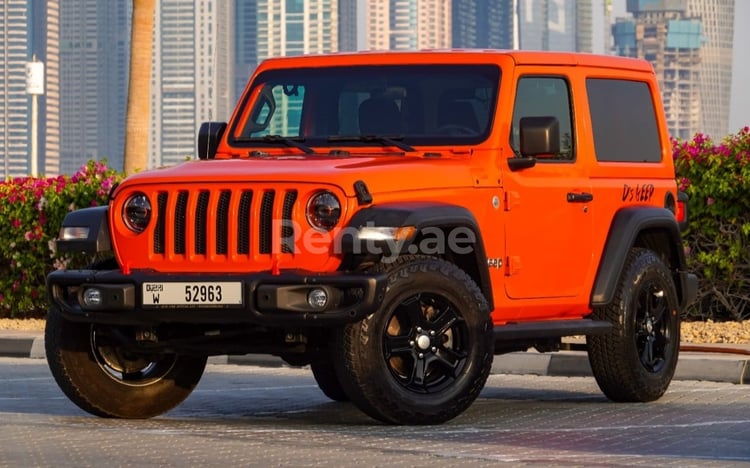 Orange Jeep Wrangler en location à Abu-Dhabi