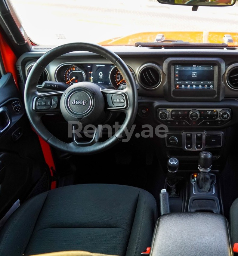 Orange Jeep Wrangler for rent in Dubai 1