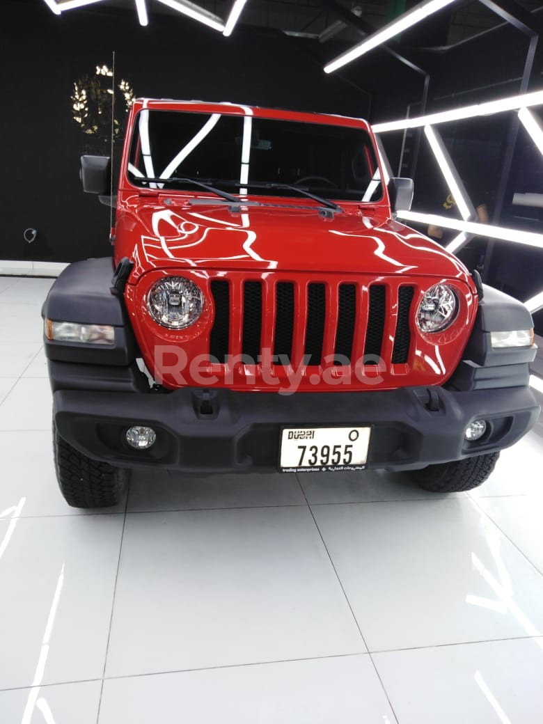 rojo Jeep Wrangler en alquiler en Dubai 1